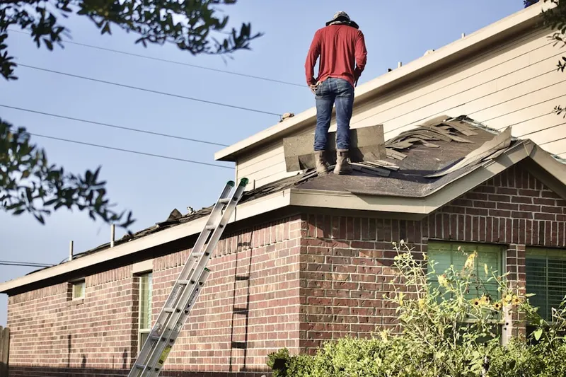 Professional roofer working on a residential roof in Hickory Ridge